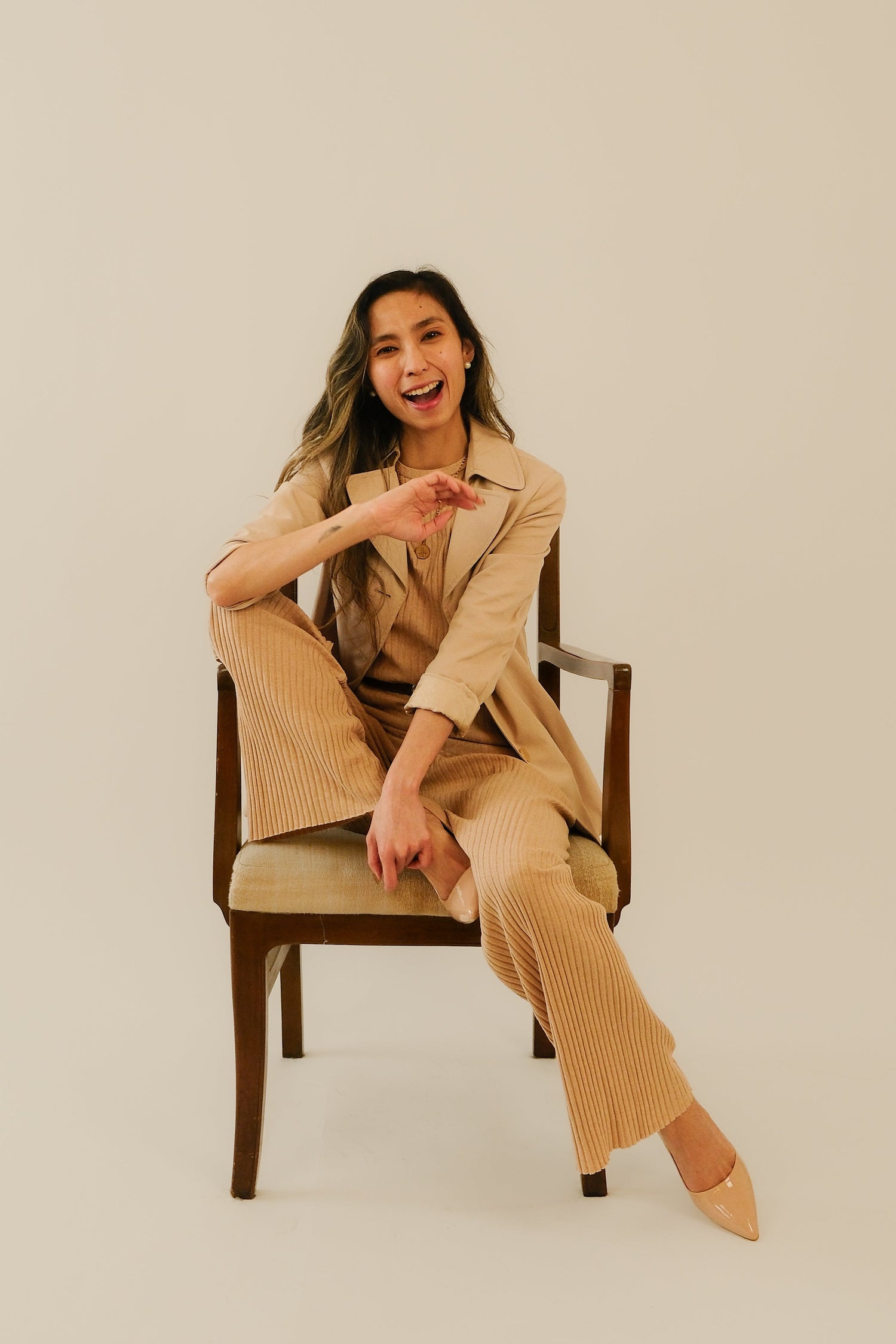 woman in a suit laughing helping with branding strategy